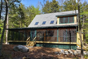 Home with wrap around screen porch and skylights.