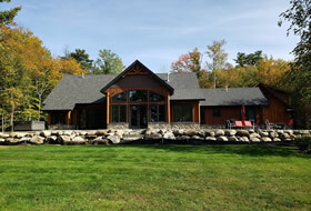 Custom two-story home with rock wall.