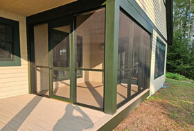 Entrance to a home with a screened in porch.