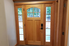 Front door and entrance way with side windows.