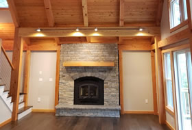 Great room with stone fireplace and tounge and groove ceiling.