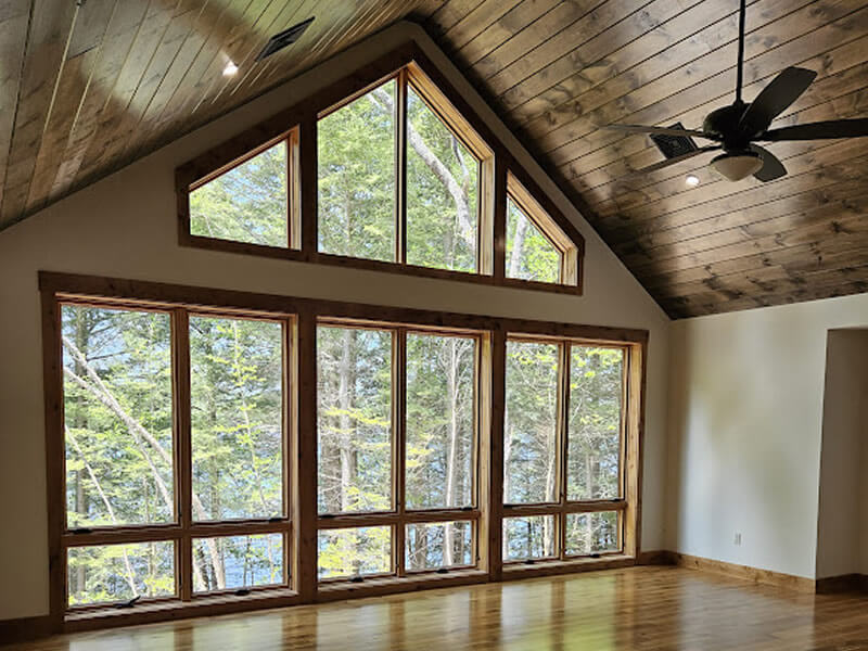 Interior great rroom with large windows overlooking the lake.